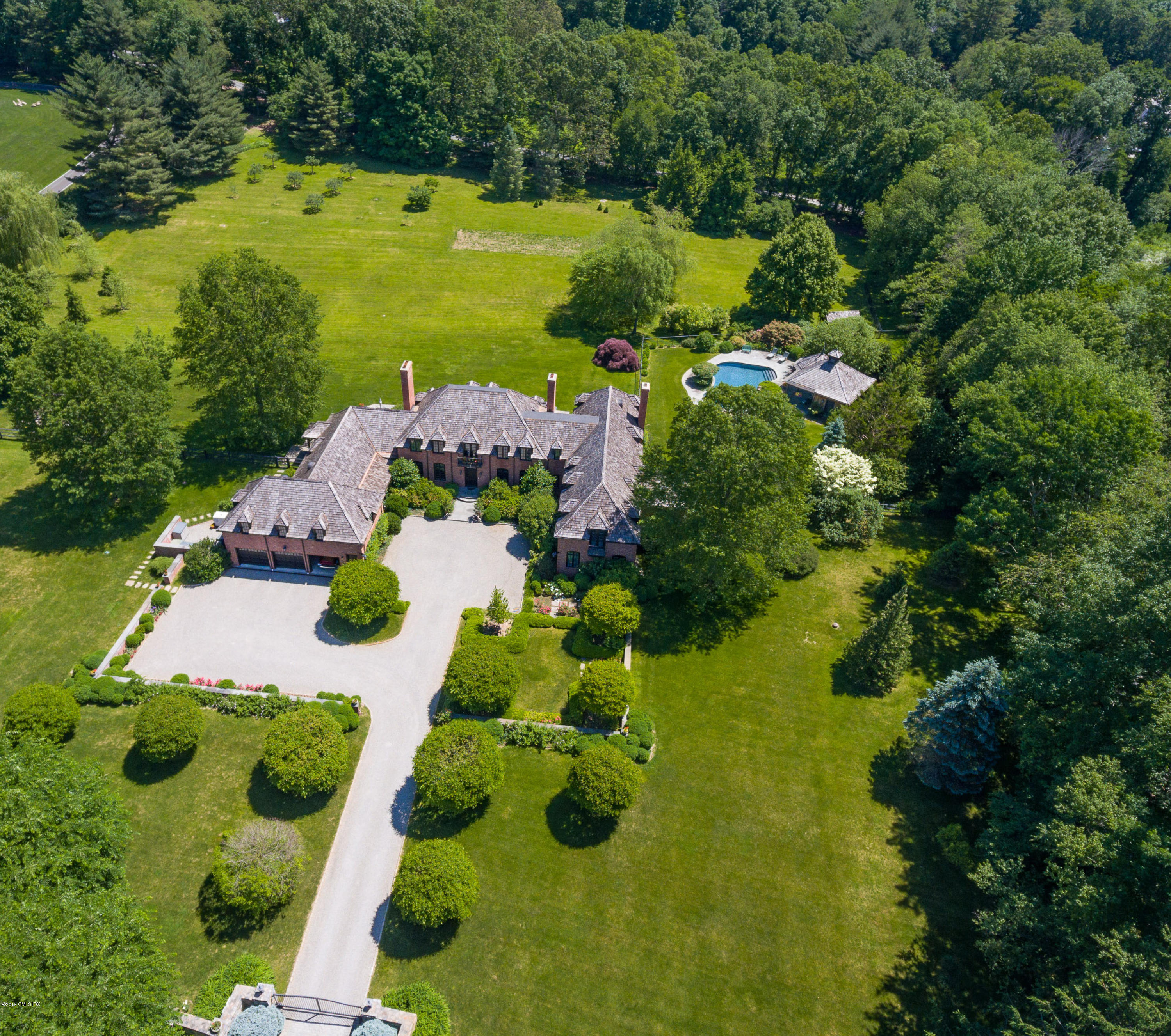 55 Mooreland Road Greenwich, CT 06831 - Photo 1 of 43 an aerial view of a house with yard swimming pool and outdoor seating
