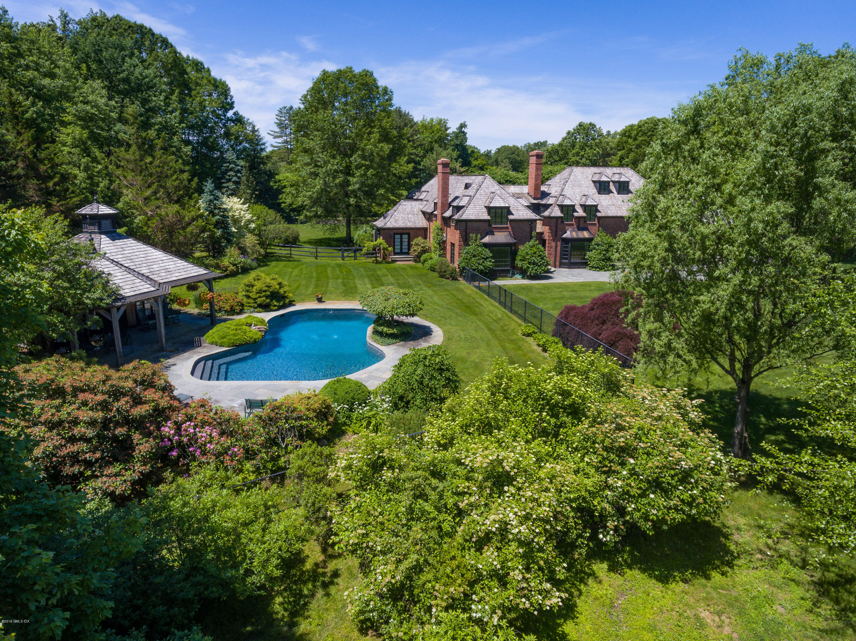55 Mooreland Road Greenwich, CT 06831 - Photo 11 of 43 a backyard of a house with a yard and outdoor seating