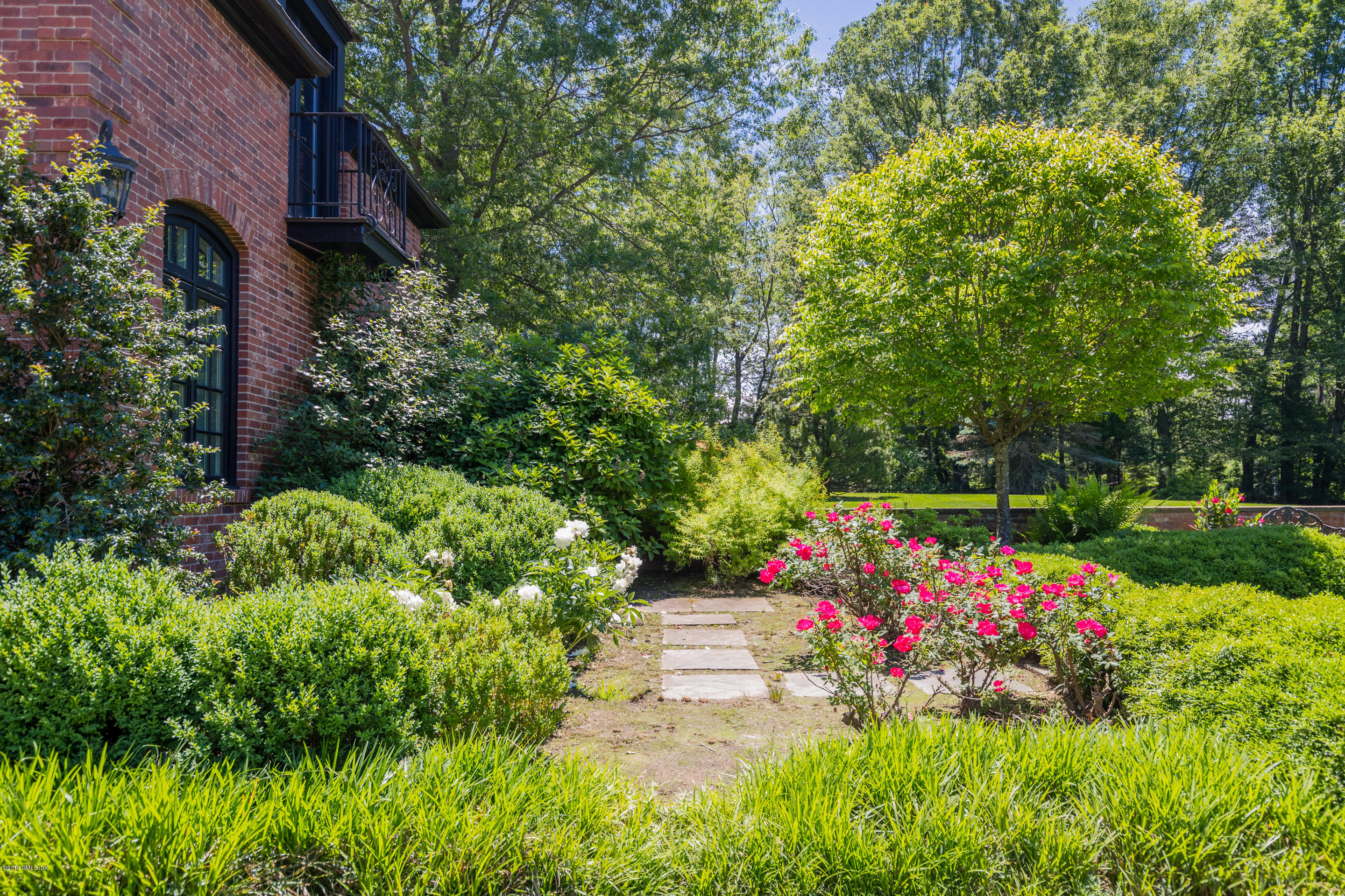 55 Mooreland Road Greenwich, CT 06831 - Photo 12 of 43 a view of a flower in a garden with statue