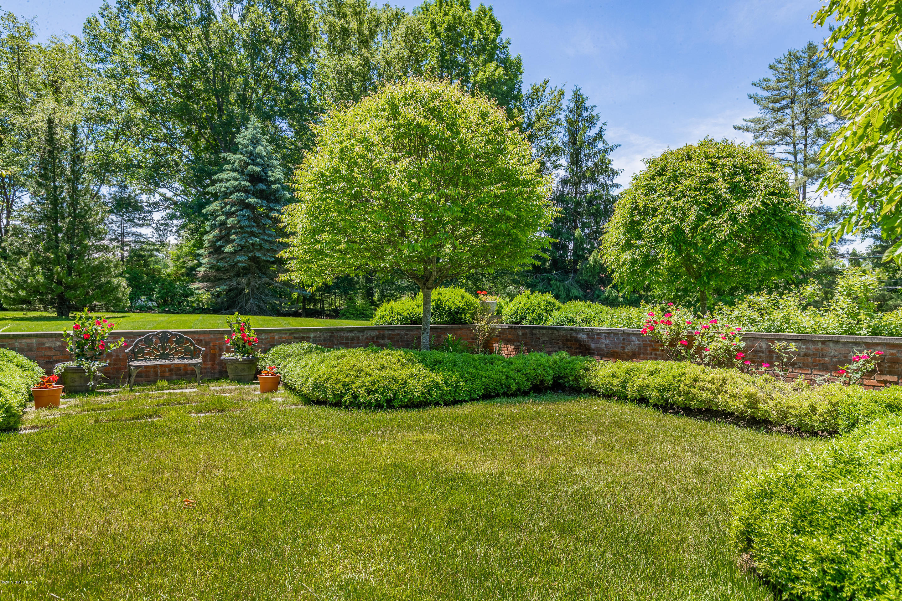 55 Mooreland Road Greenwich, CT 06831 - Photo 17 of 43 a view of a garden with large trees