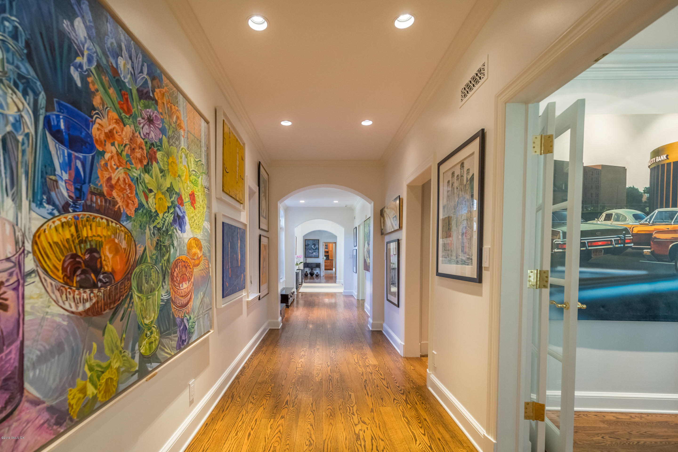 55 Mooreland Road Greenwich, CT 06831 - Photo 19 of 43 a view of a hallway with wooden floor and a fireplace