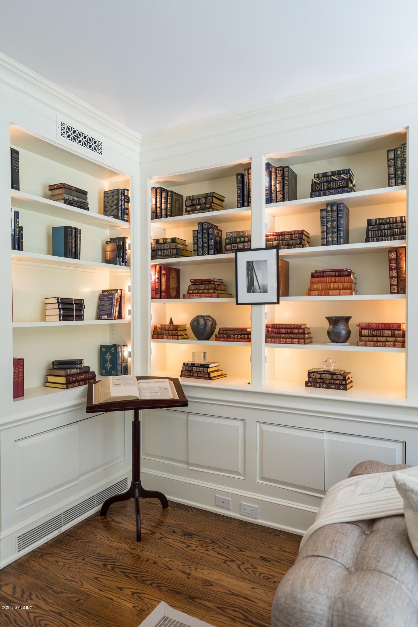 55 Mooreland Road Greenwich, CT 06831 - Photo 23 of 43 a living room with couches bookshelf and painting on the wall