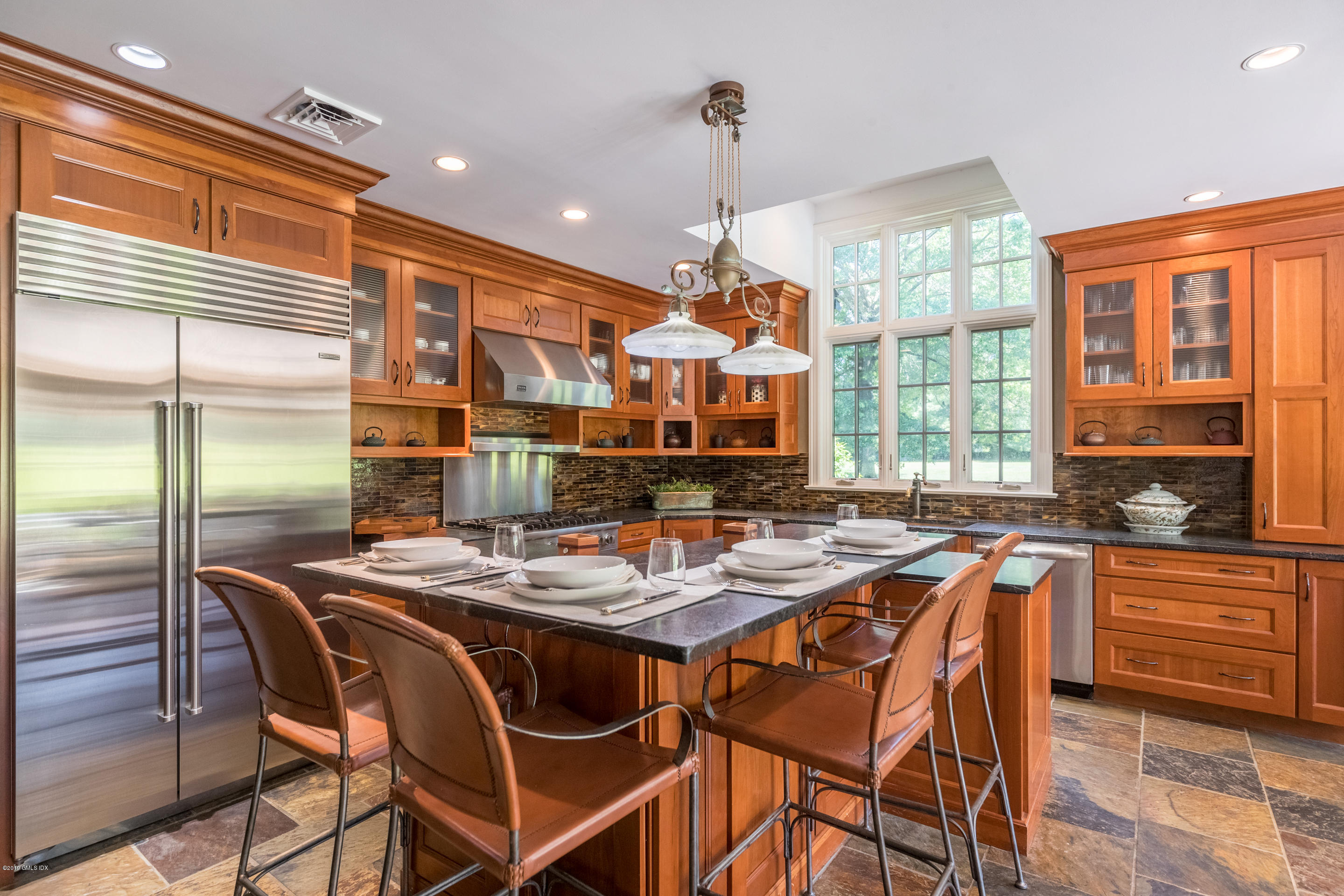 55 Mooreland Road Greenwich, CT 06831 - Photo 30 of 43 a kitchen with a stove a table and chairs in it