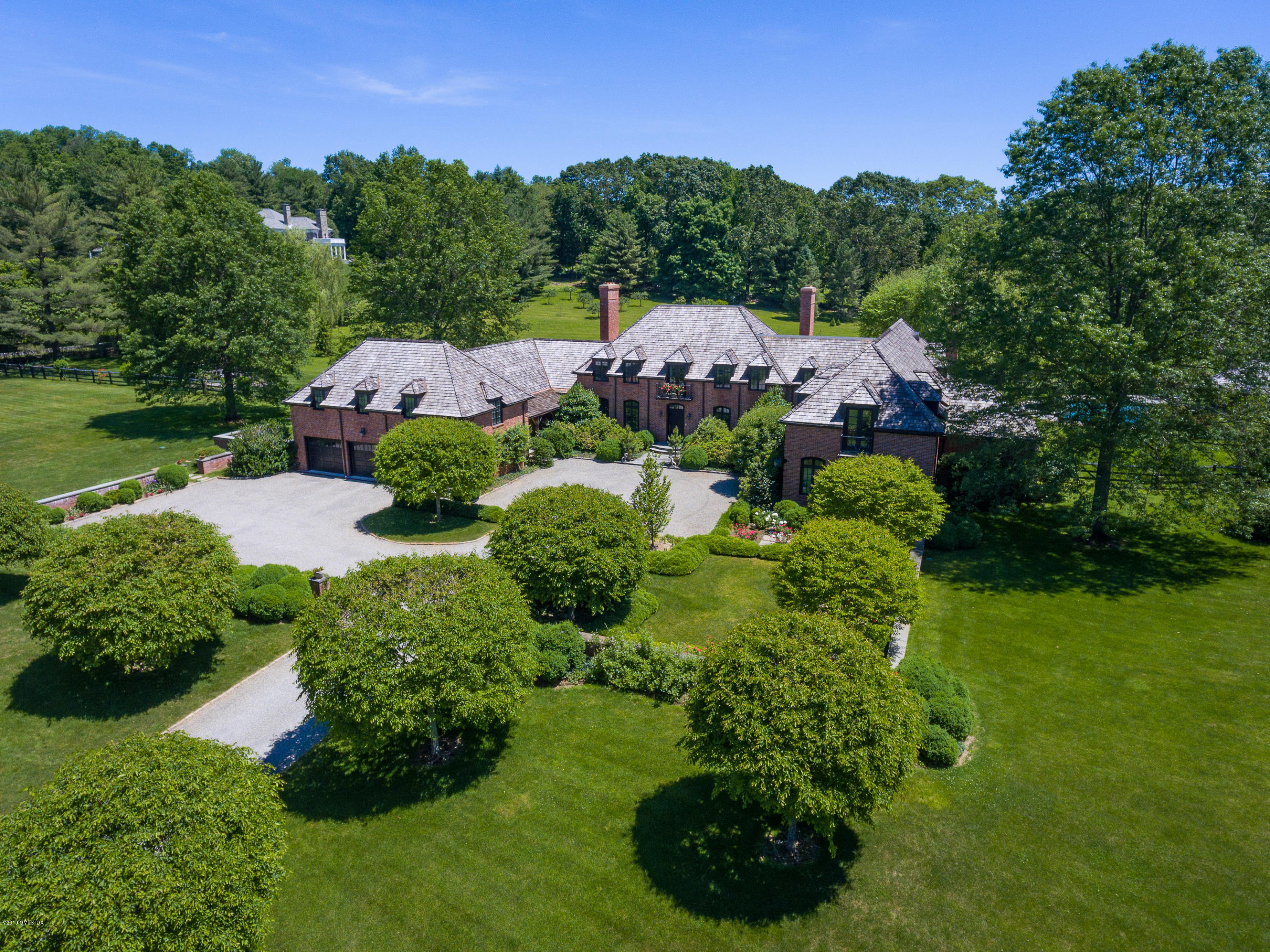 55 Mooreland Road Greenwich, CT 06831 - Photo 3 of 43 a view of a garden with plants and a fountain