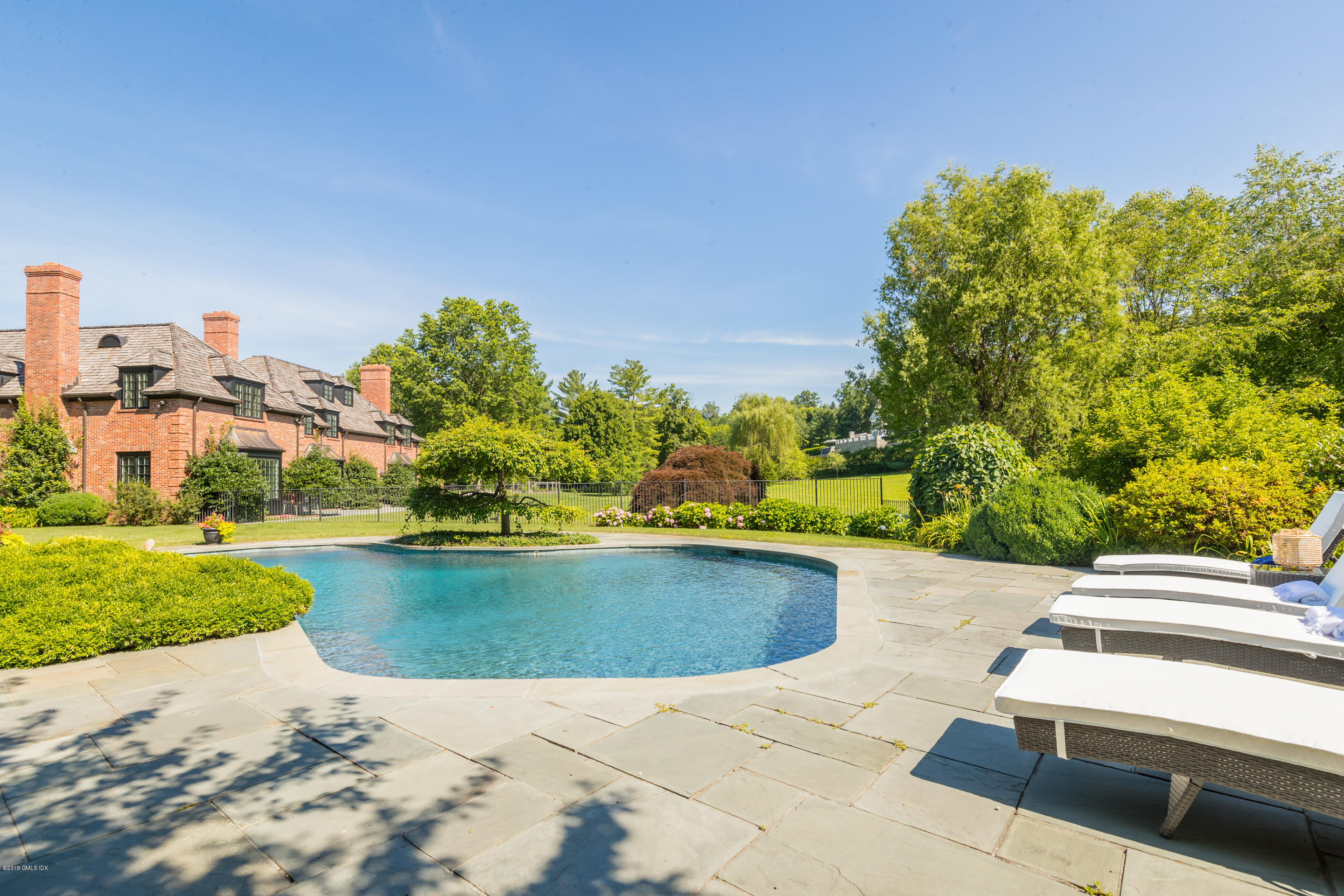 55 Mooreland Road Greenwich, CT 06831 - Photo 35 of 43 a view of a swimming pool with a patio