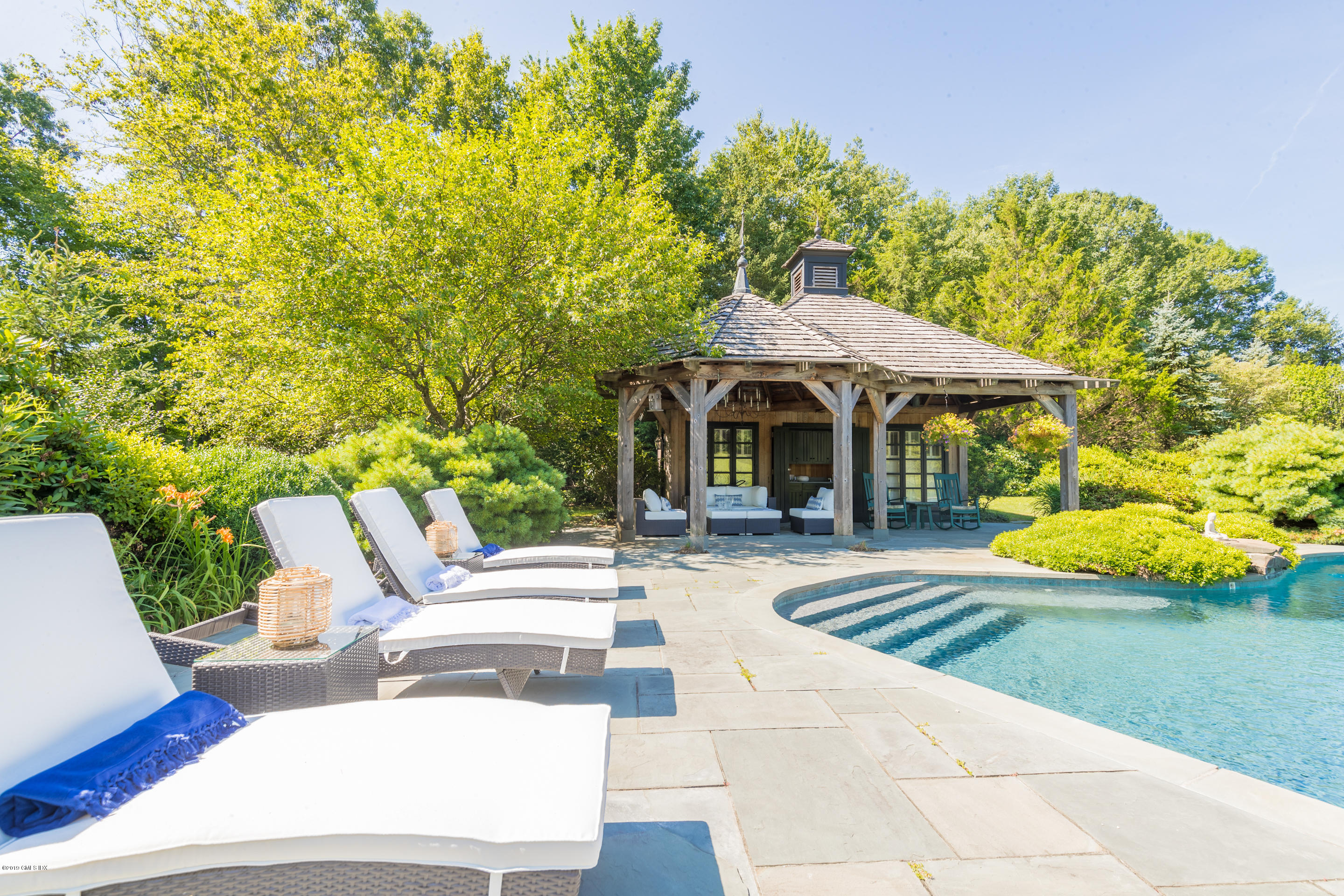 55 Mooreland Road Greenwich, CT 06831 - Photo 36 of 43 a patio with sofas fire pit table and chairs