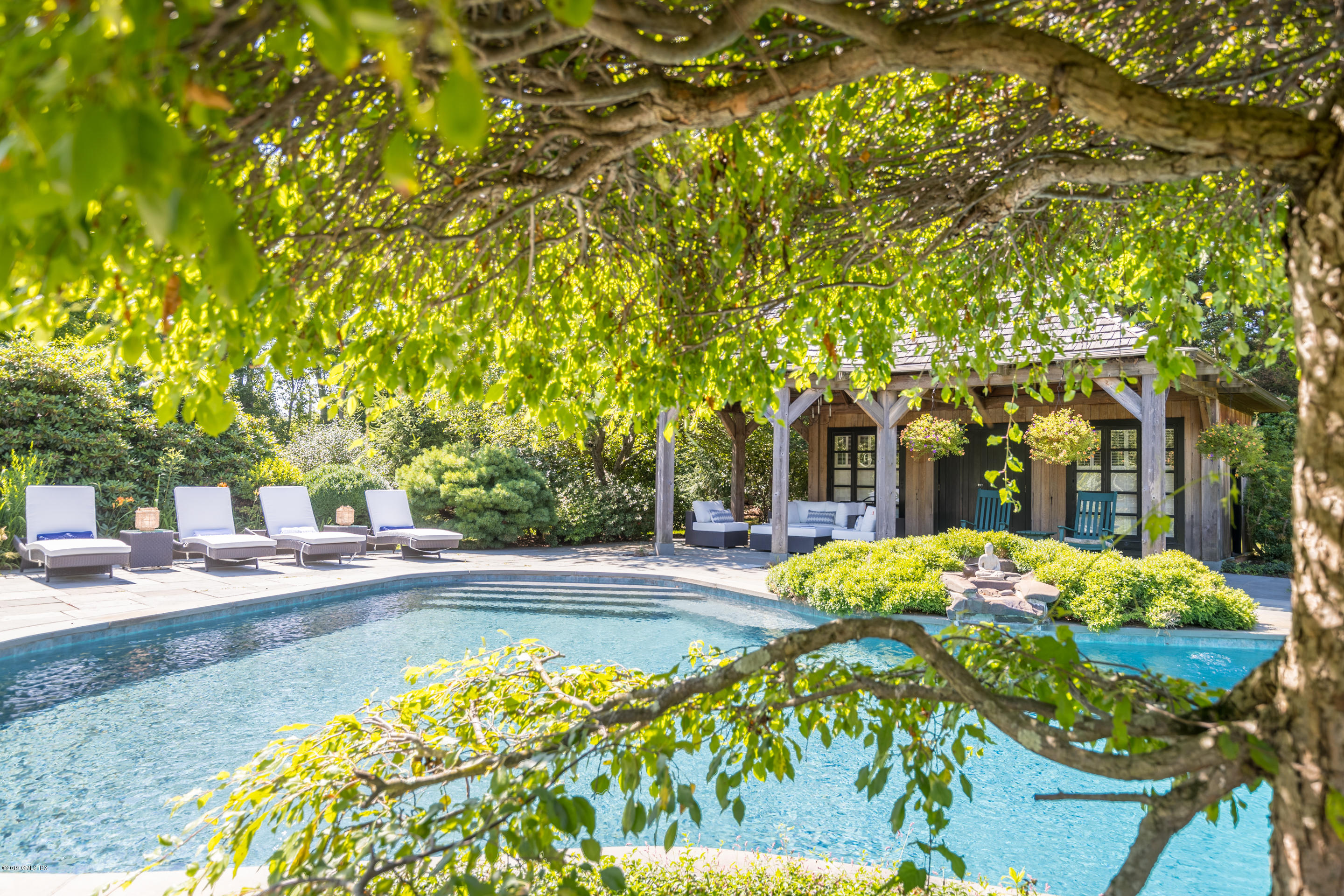 55 Mooreland Road Greenwich, CT 06831 - Photo 38 of 43 a front view of a house with a yard