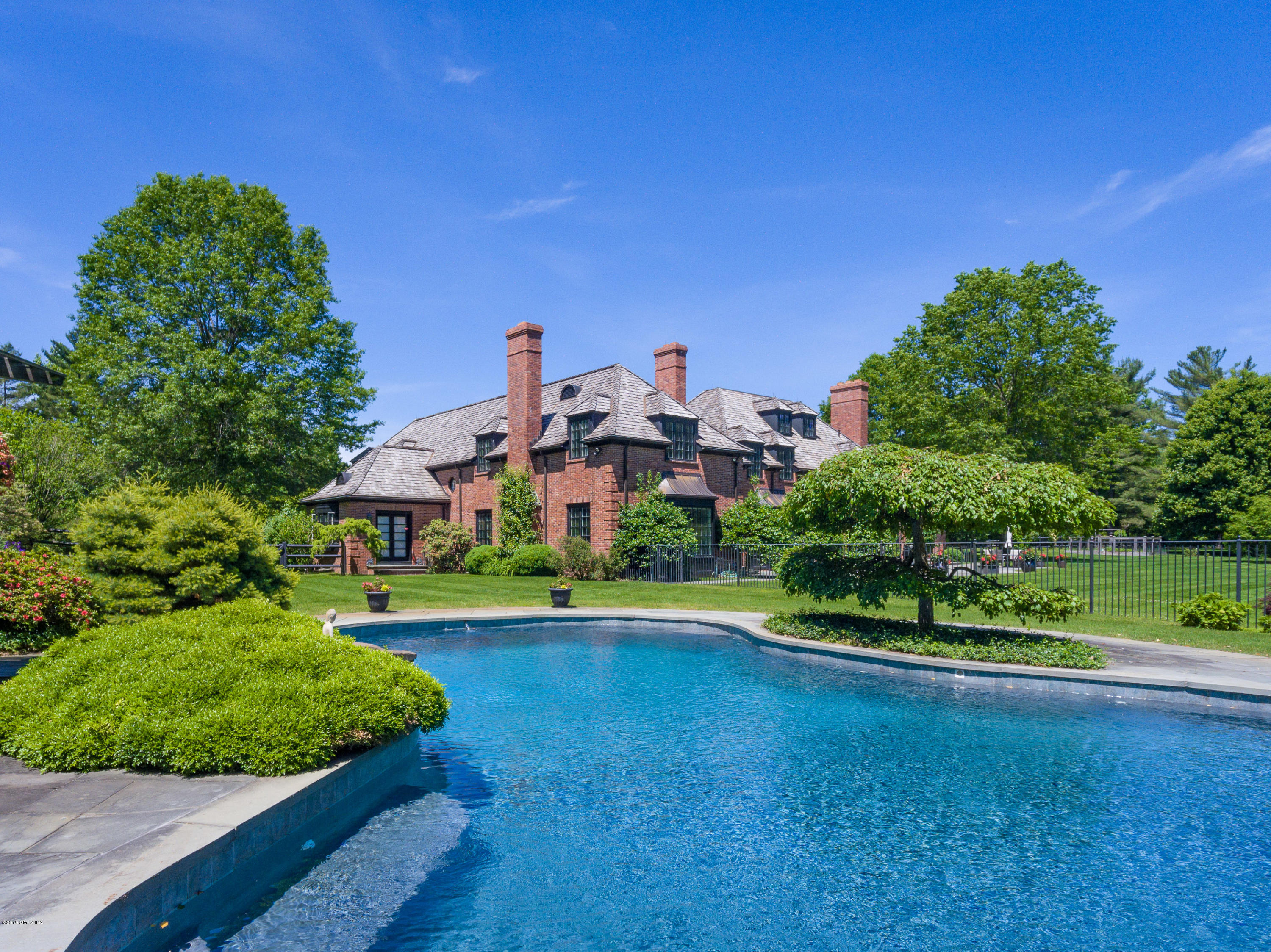 55 Mooreland Road Greenwich, CT 06831 - Photo 5 of 43 a front view of a house with a yard