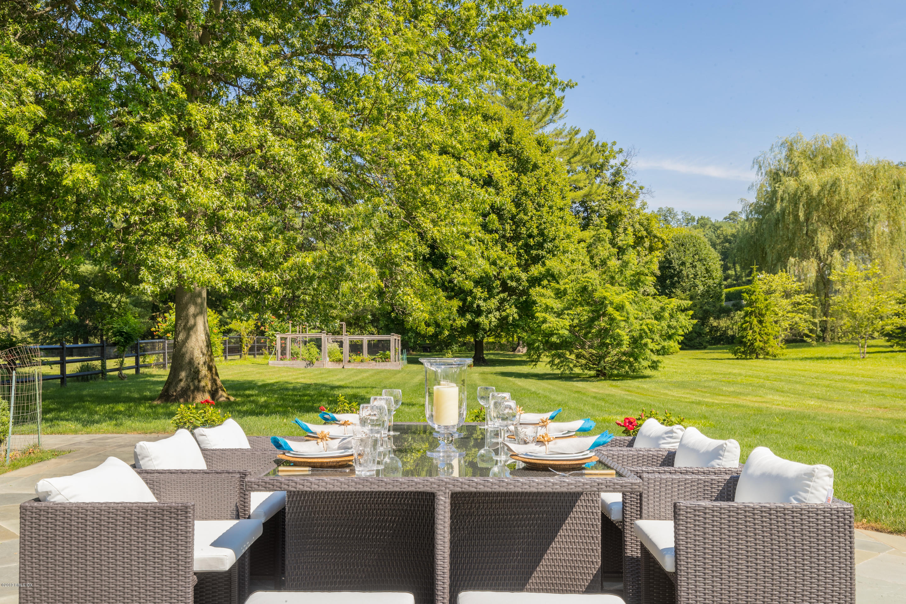 55 Mooreland Road Greenwich, CT 06831 - Photo 7 of 43 a view of a swimming pool and lounge chairs in back yard of the house