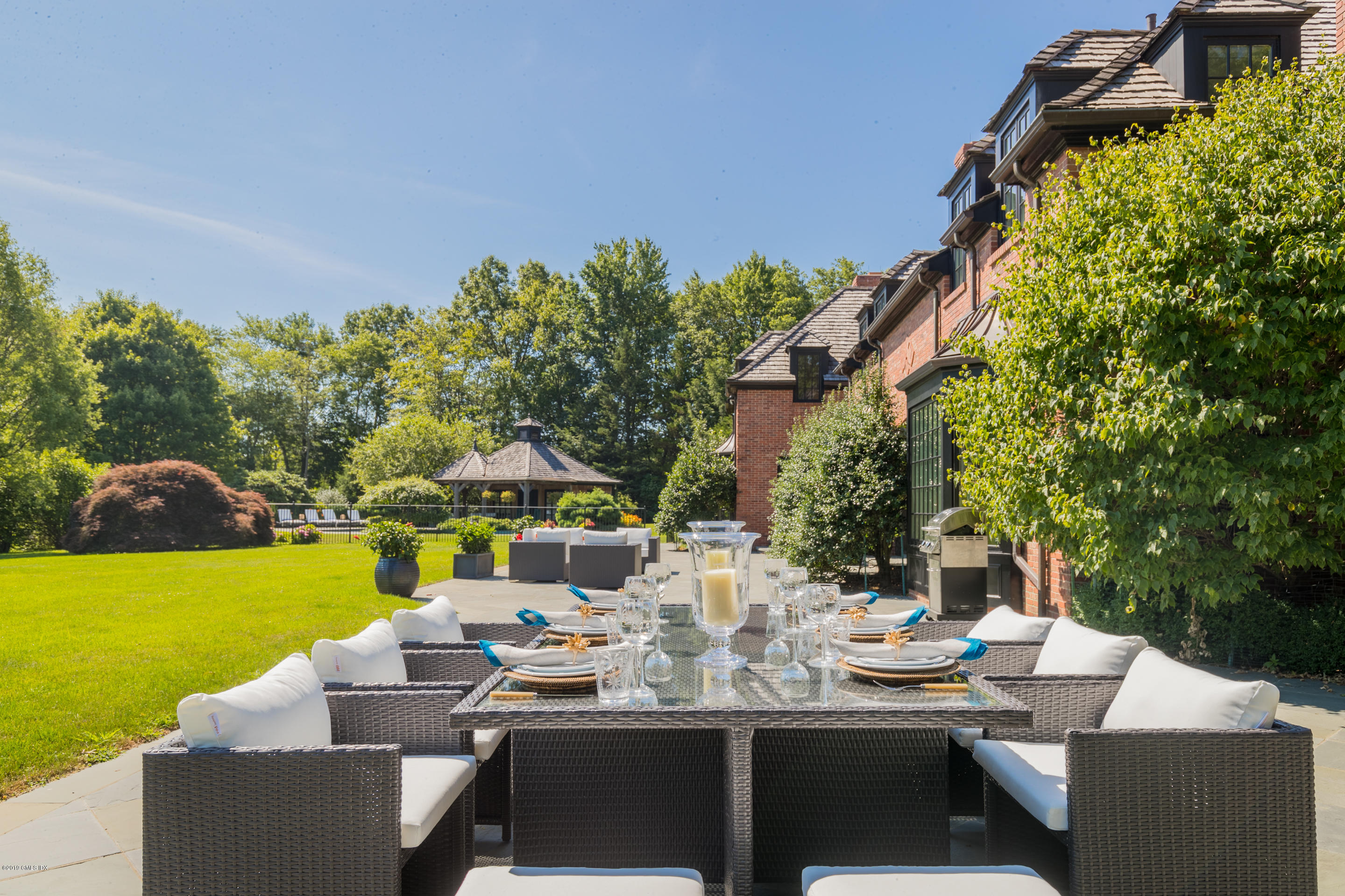 55 Mooreland Road Greenwich, CT 06831 - Photo 8 of 43 a view of a patio with couches table and chairs and potted plants