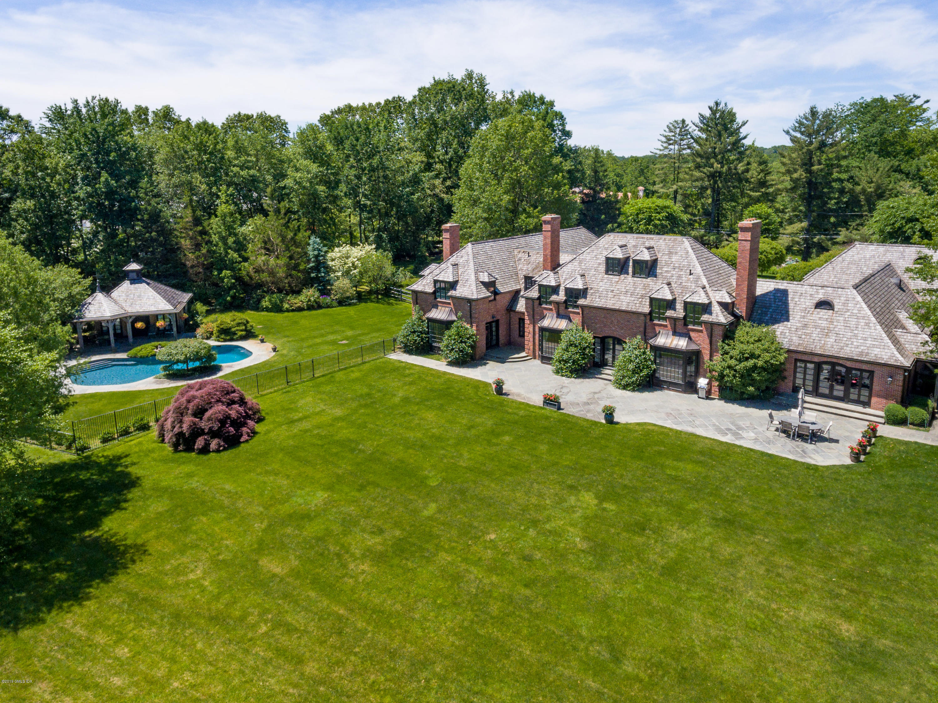 55 Mooreland Road Greenwich, CT 06831 - Photo 10 of 43 a view of a house with a garden and parking space
