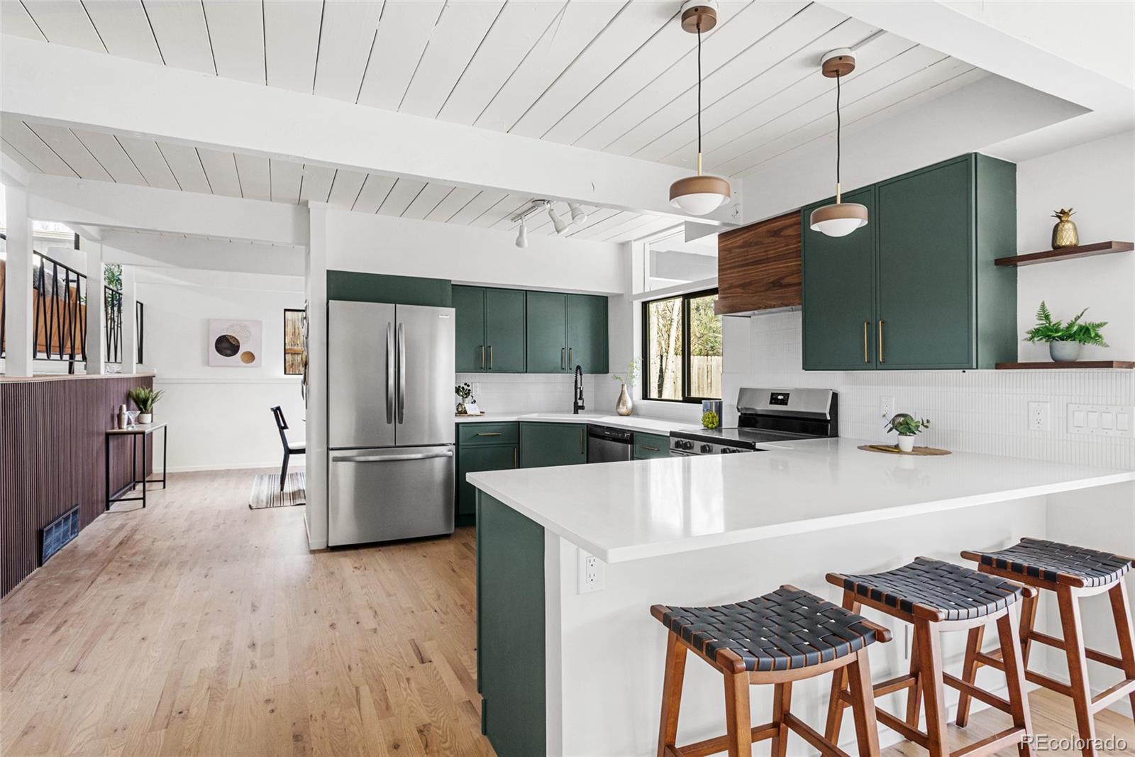 1812 South Ivanhoe Street Denver, CO 80224 - Photo 16 of 46 a kitchen with refrigerator a table and chairs
