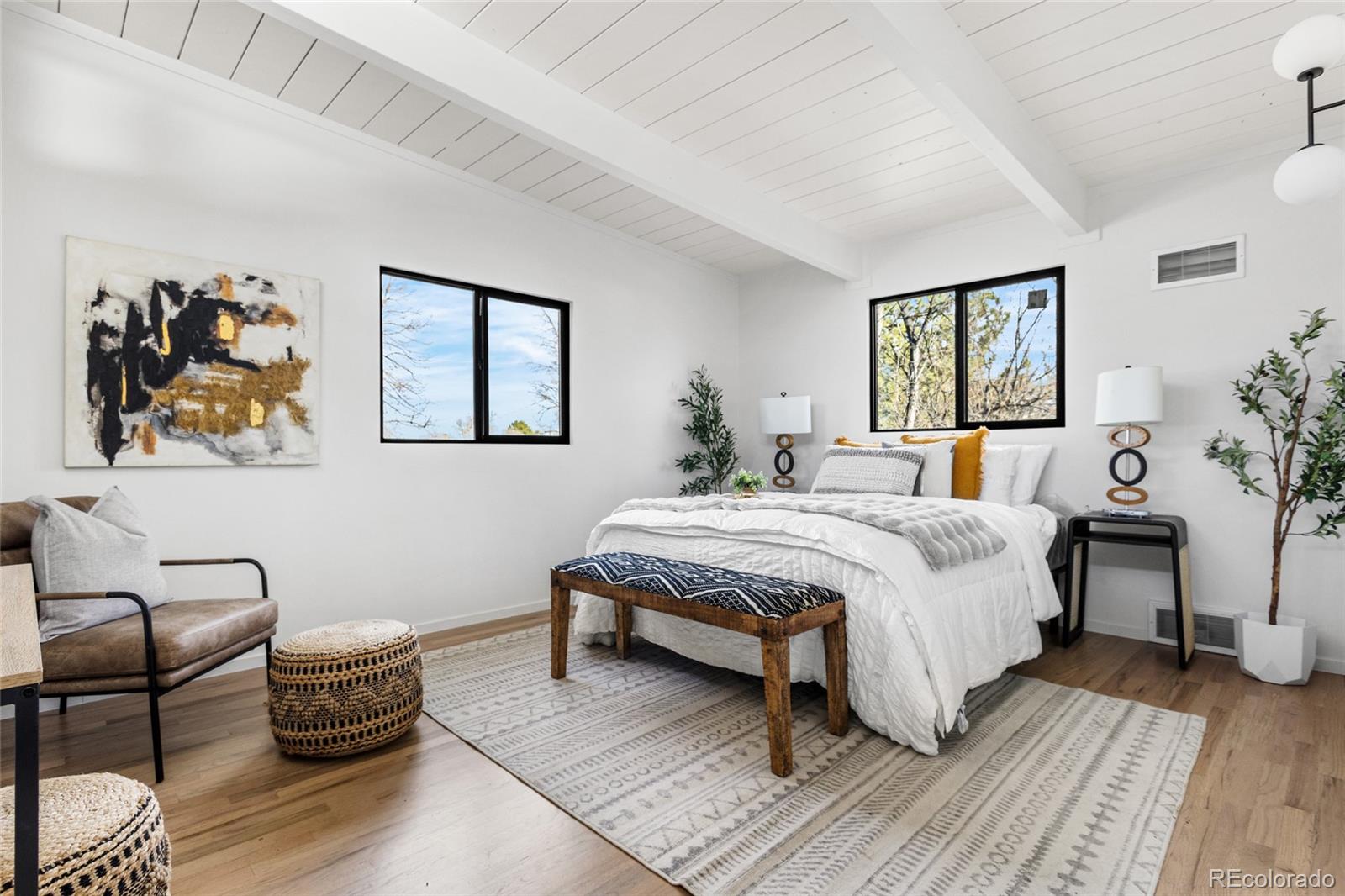 1812 South Ivanhoe Street Denver, CO 80224 - Photo 22 of 46 a bedroom with a bed and a painting on the wall