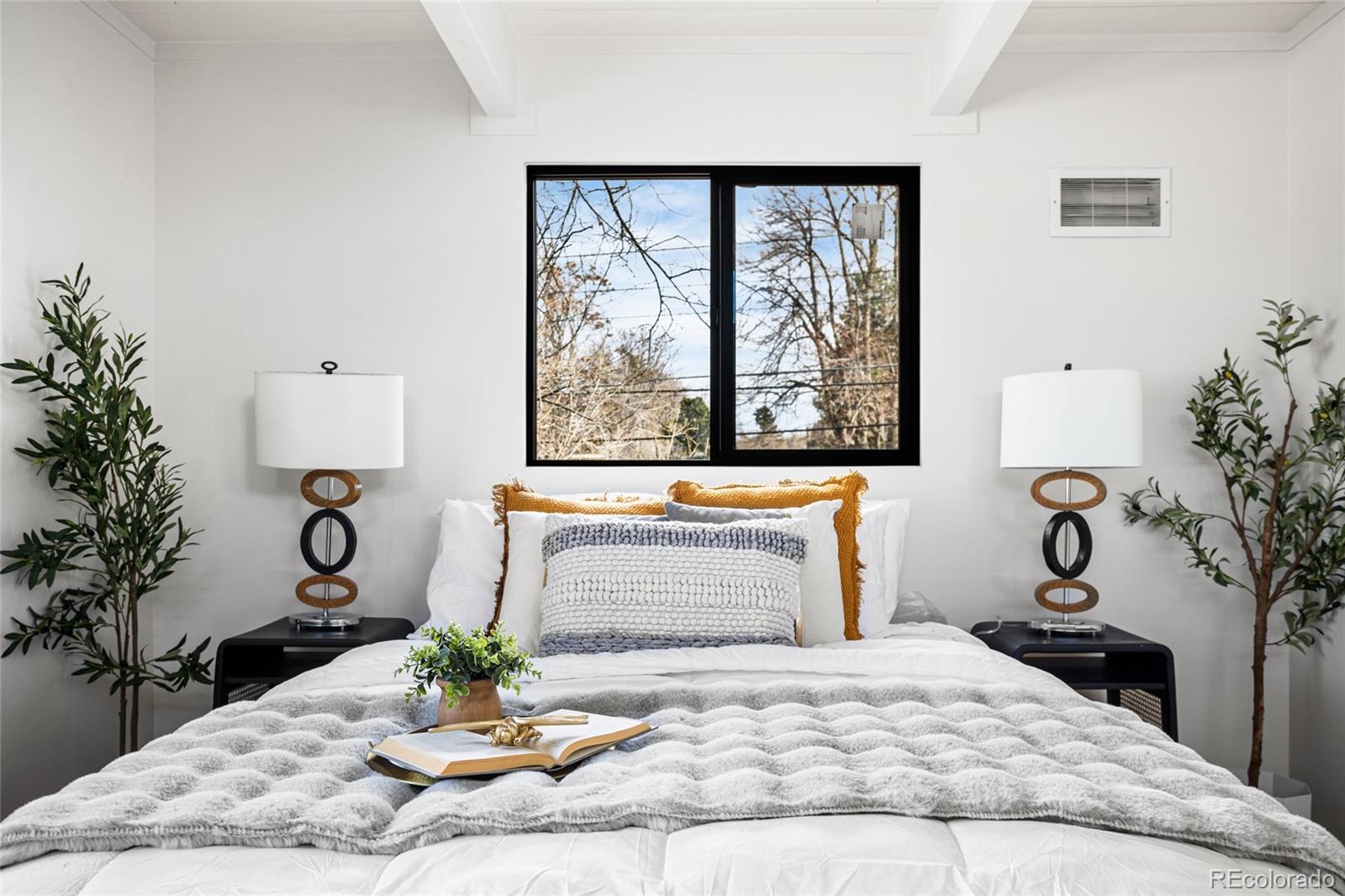 1812 South Ivanhoe Street Denver, CO 80224 - Photo 23 of 46 a bedroom with a bed and a potted plant