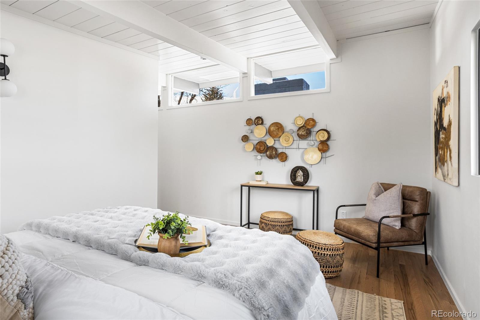 1812 South Ivanhoe Street Denver, CO 80224 - Photo 24 of 46 a bedroom with a bed and a chair