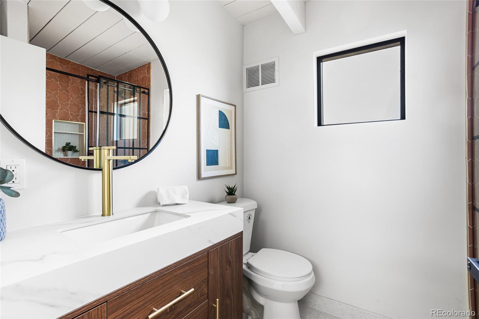 1812 South Ivanhoe Street Denver, CO 80224 - Photo 26 of 46 a bathroom with a sink and a mirror