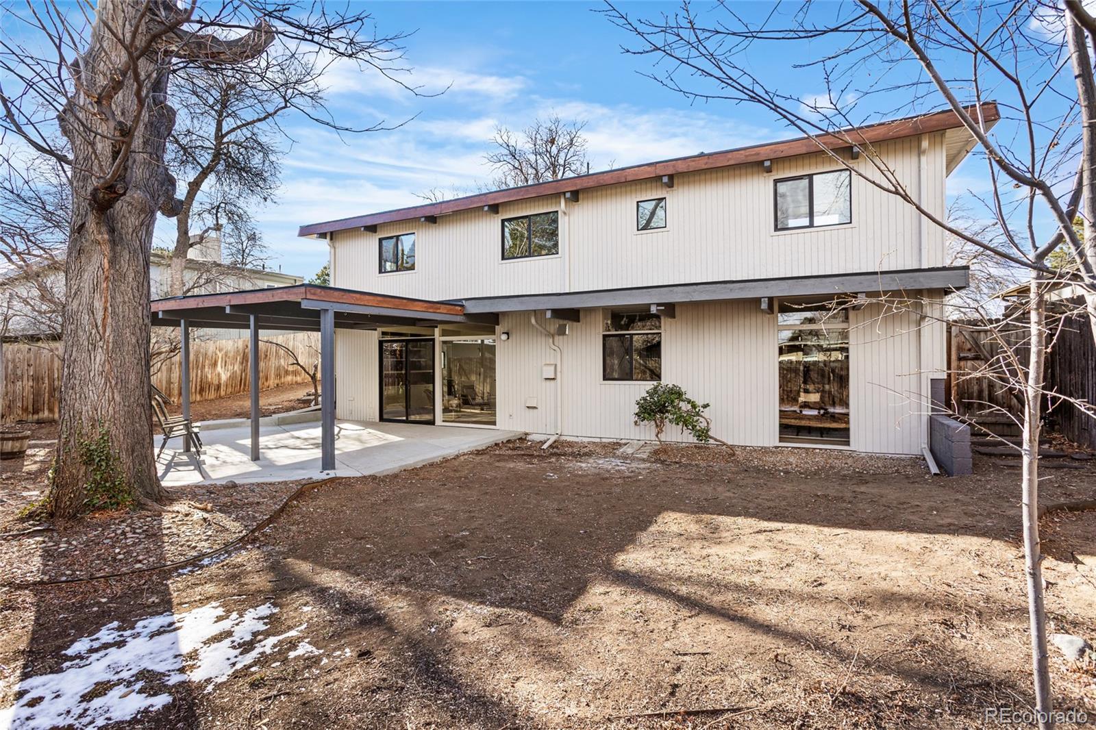 1812 South Ivanhoe Street Denver, CO 80224 - Photo 34 of 46 a front view of a house with a yard and garage