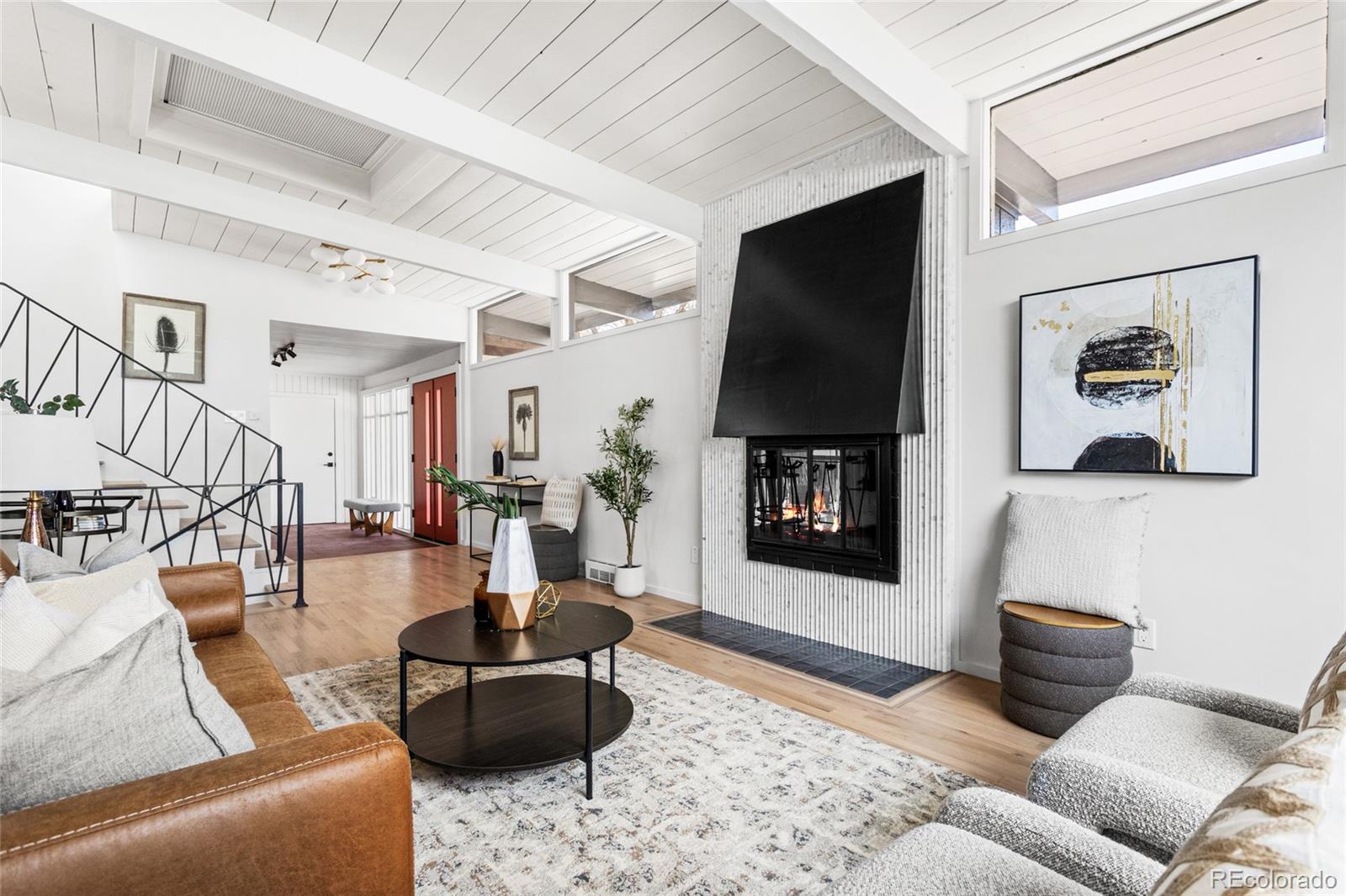 1812 South Ivanhoe Street Denver, CO 80224 - Photo 6 of 46 a living room with furniture and a flat screen tv