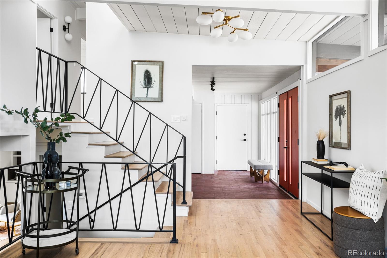 1812 South Ivanhoe Street Denver, CO 80224 - Photo 7 of 46 a view of an entryway wooden floor and chandelier