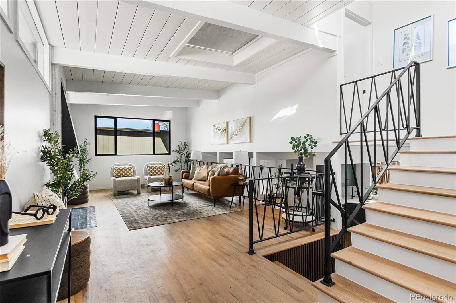 1812 South Ivanhoe Street Denver, CO 80224 - Photo 8 of 46 a living room with lots of furniture and a wooden floor