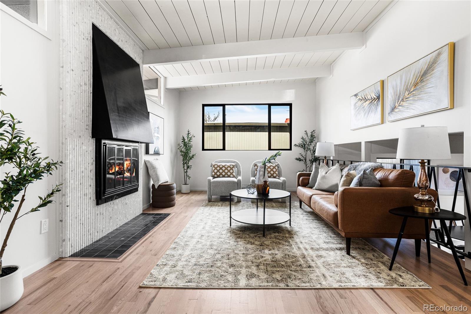 1812 South Ivanhoe Street Denver, CO 80224 - Photo 9 of 46 a living room with furniture and a fireplace