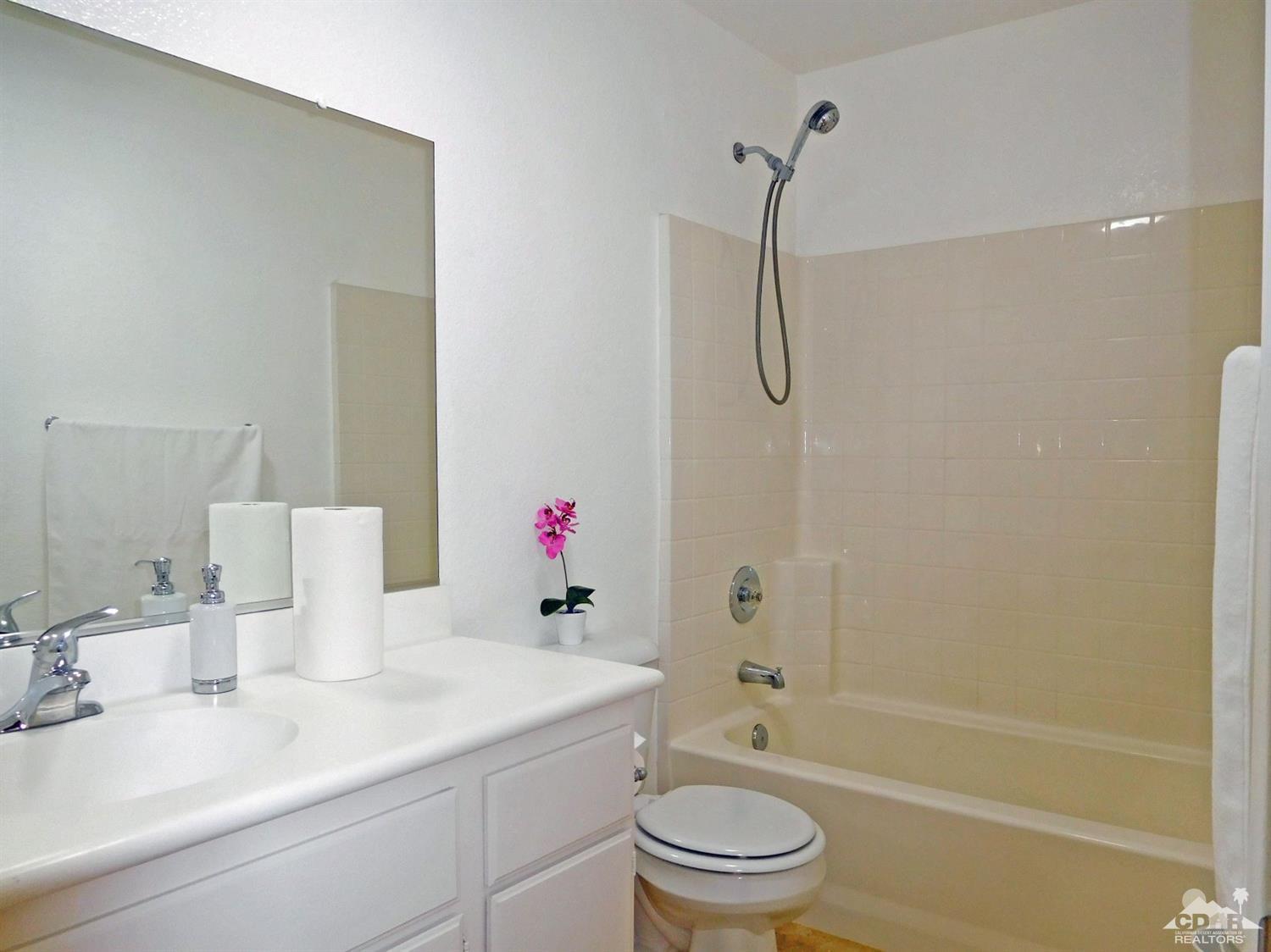 49699 Truman Way Indio, CA 92201 - Photo 15 of 19 a bathroom with a sink vanity mirror and toilet
