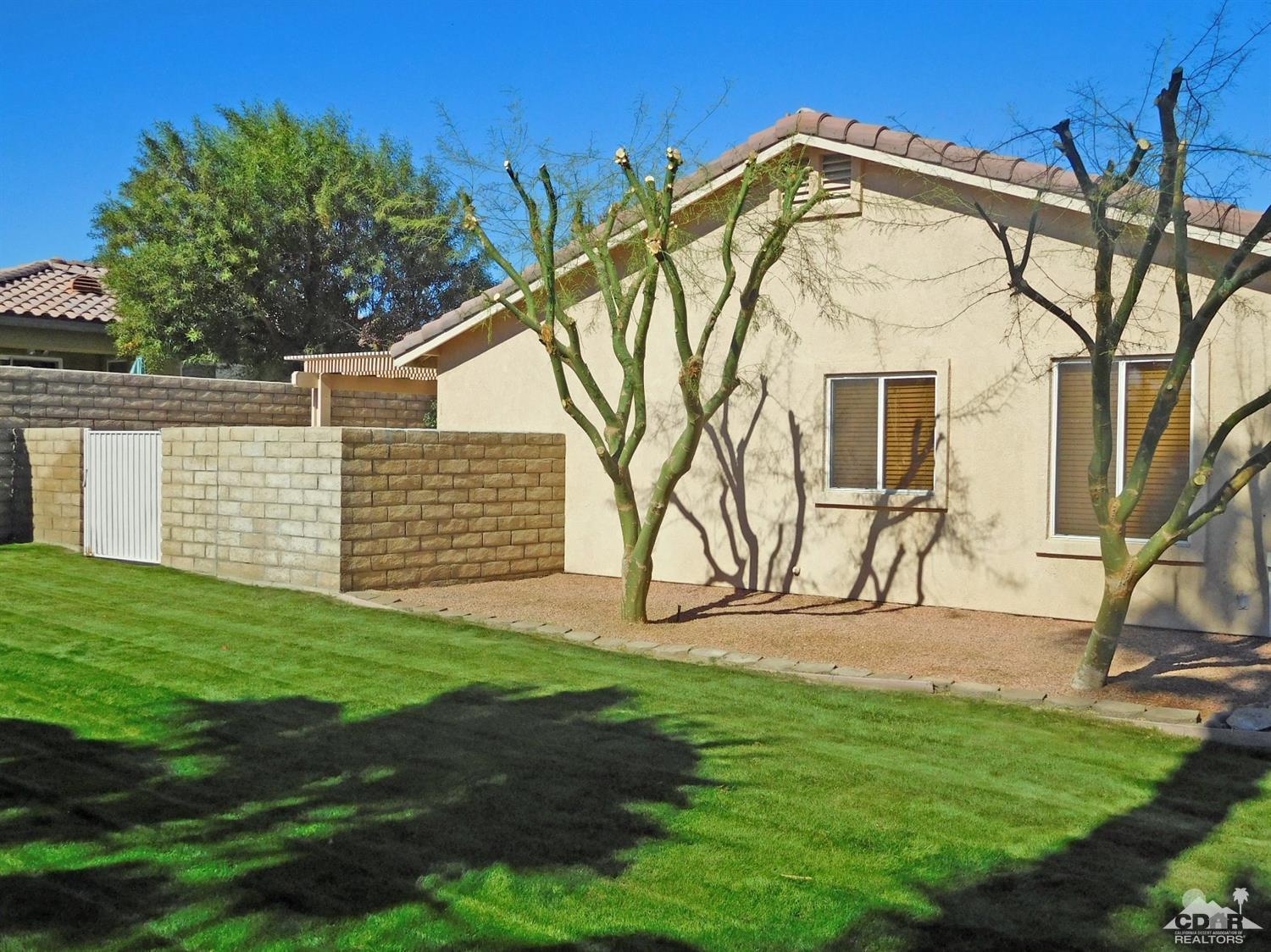 49699 Truman Way Indio, CA 92201 - Photo 17 of 19 a view of a house with a yard