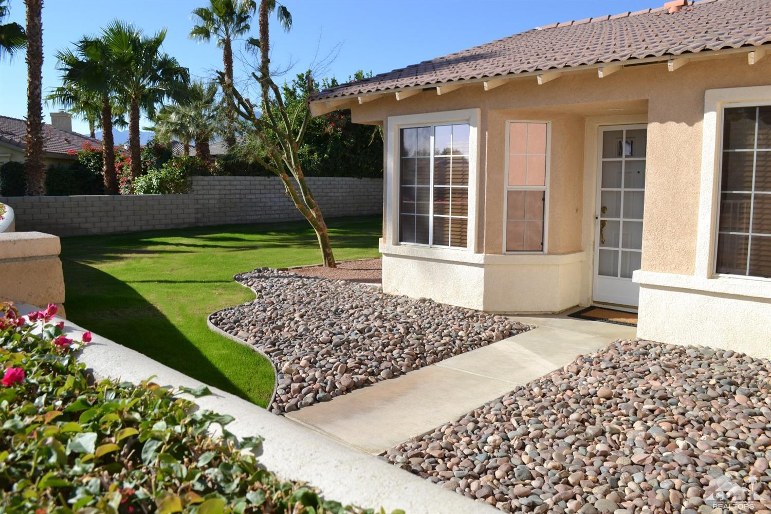 49699 Truman Way Indio, CA 92201 - Photo 2 of 19 front view of a house with a yard