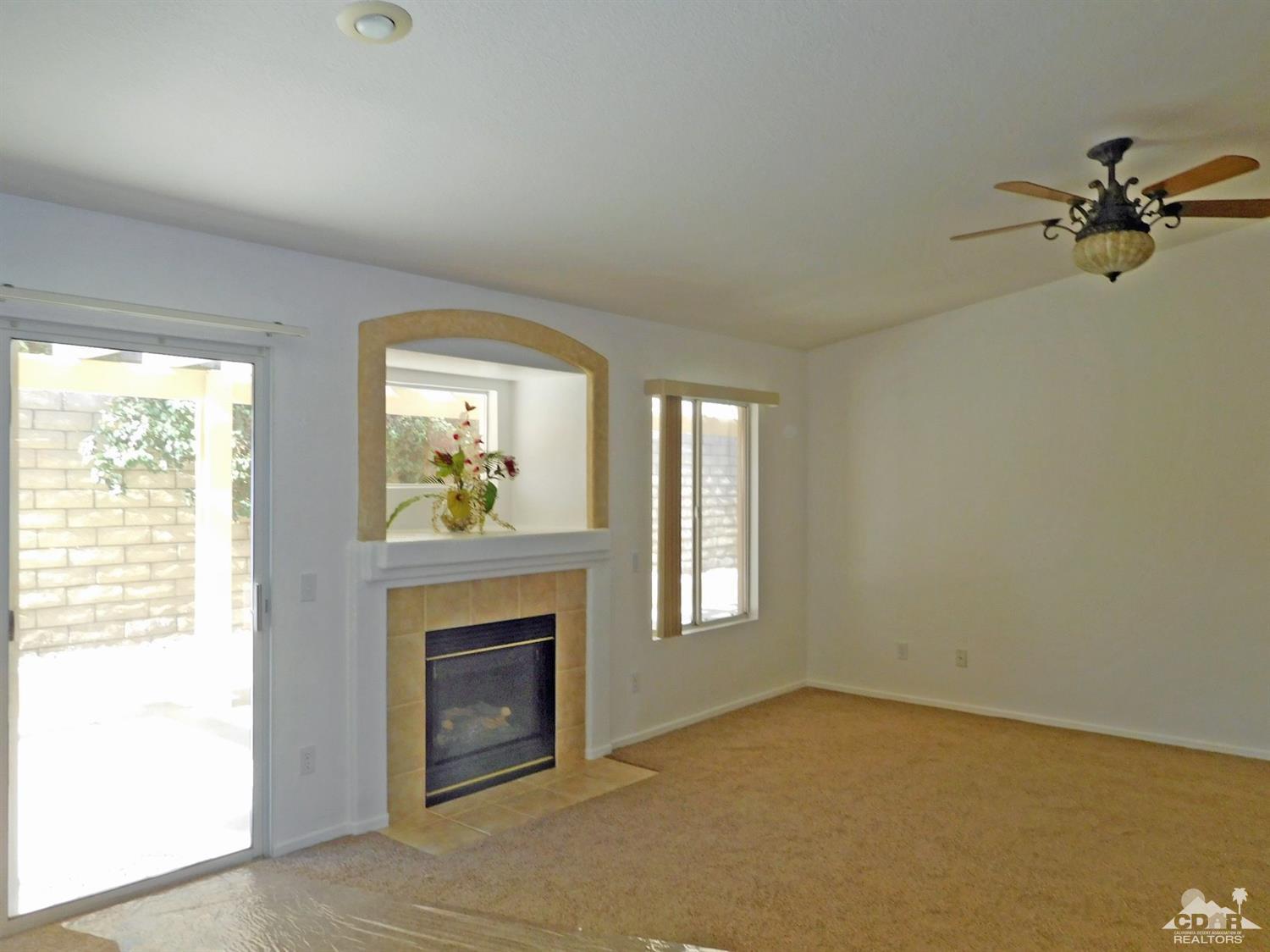 49699 Truman Way Indio, CA 92201 - Photo 3 of 19 a living room with furniture and a fireplace