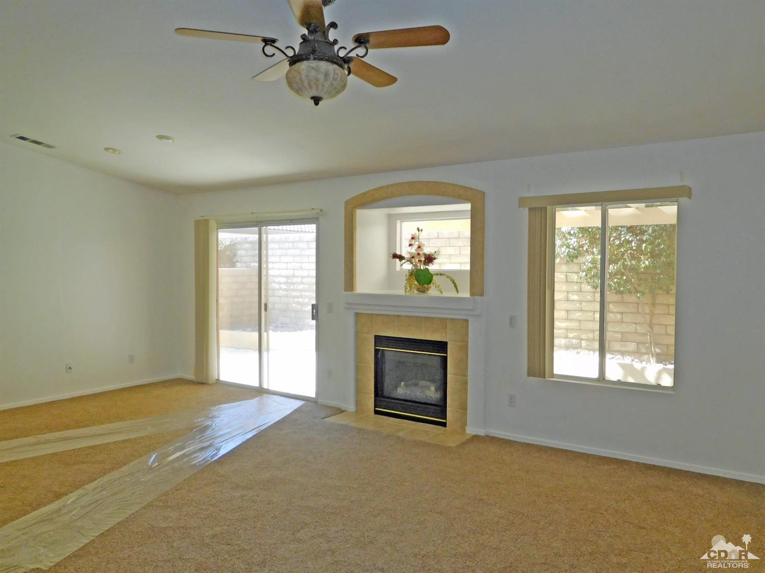 49699 Truman Way Indio, CA 92201 - Photo 4 of 19 a view of an empty room with a window and fireplace
