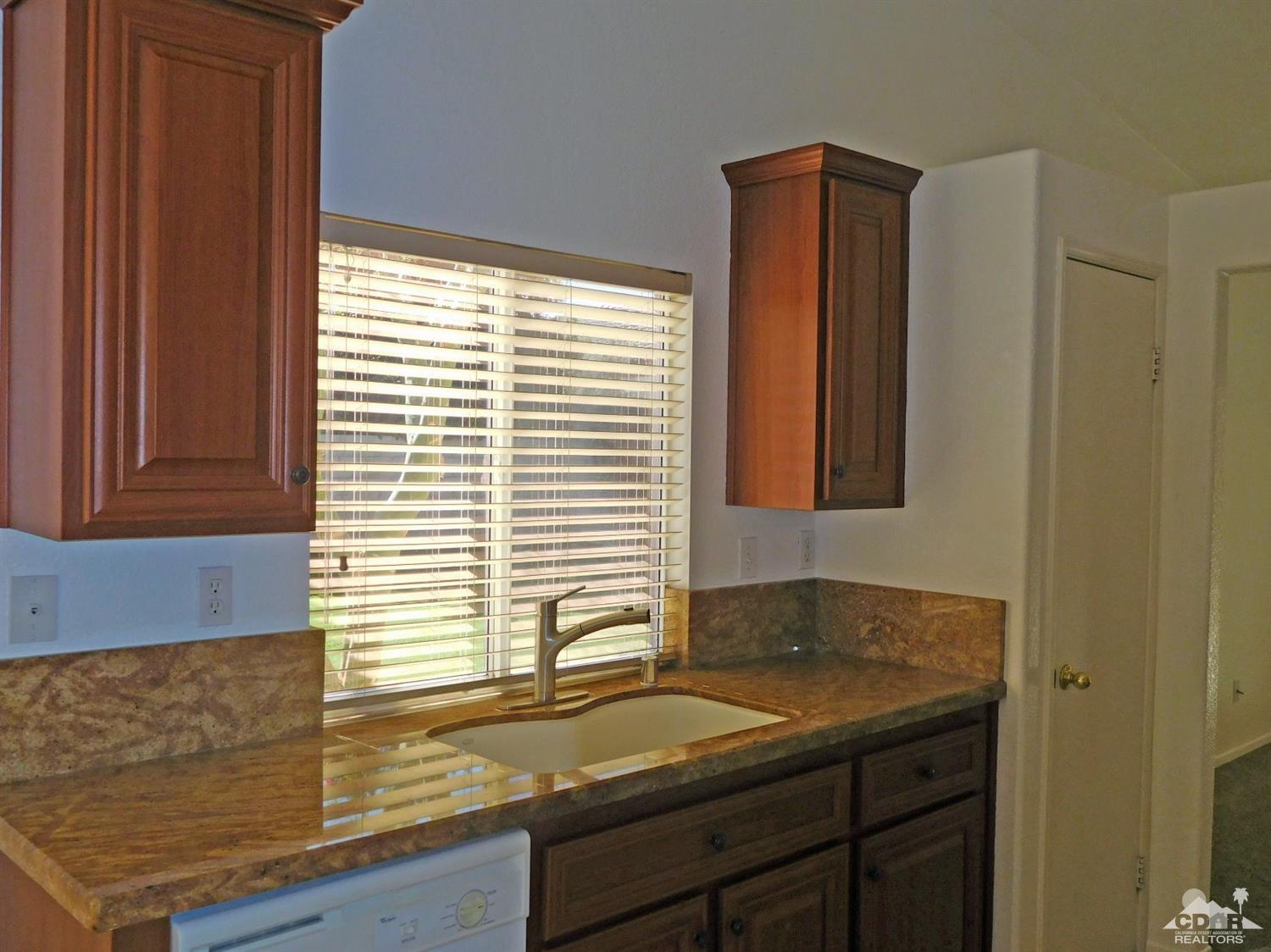49699 Truman Way Indio, CA 92201 - Photo 9 of 19 a bathroom with a granite countertop sink and a window