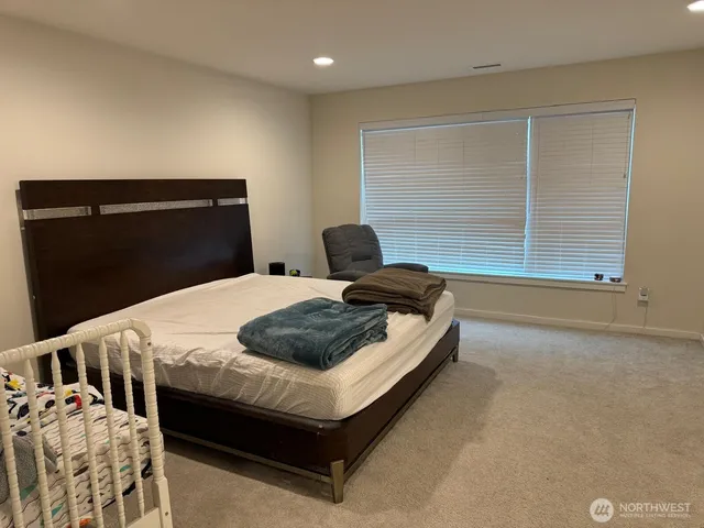 a bedroom with a bed and window