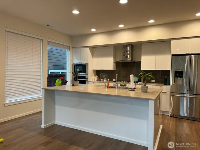 a kitchen with refrigerator and cabinets