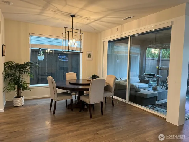 a dining room with furniture and wooden floor