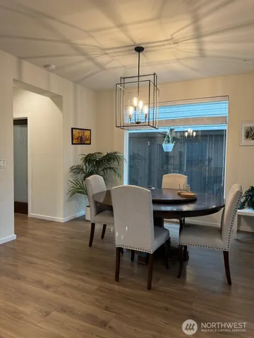 a view of a dining room with furniture and wooden floor