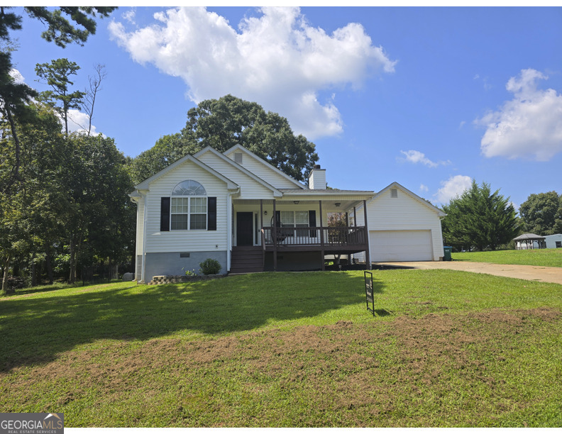 a front view of a house with a garden and yard