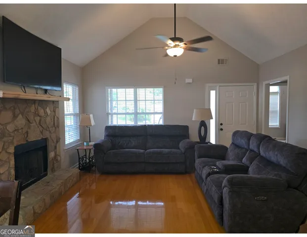 a living room with furniture and a fireplace
