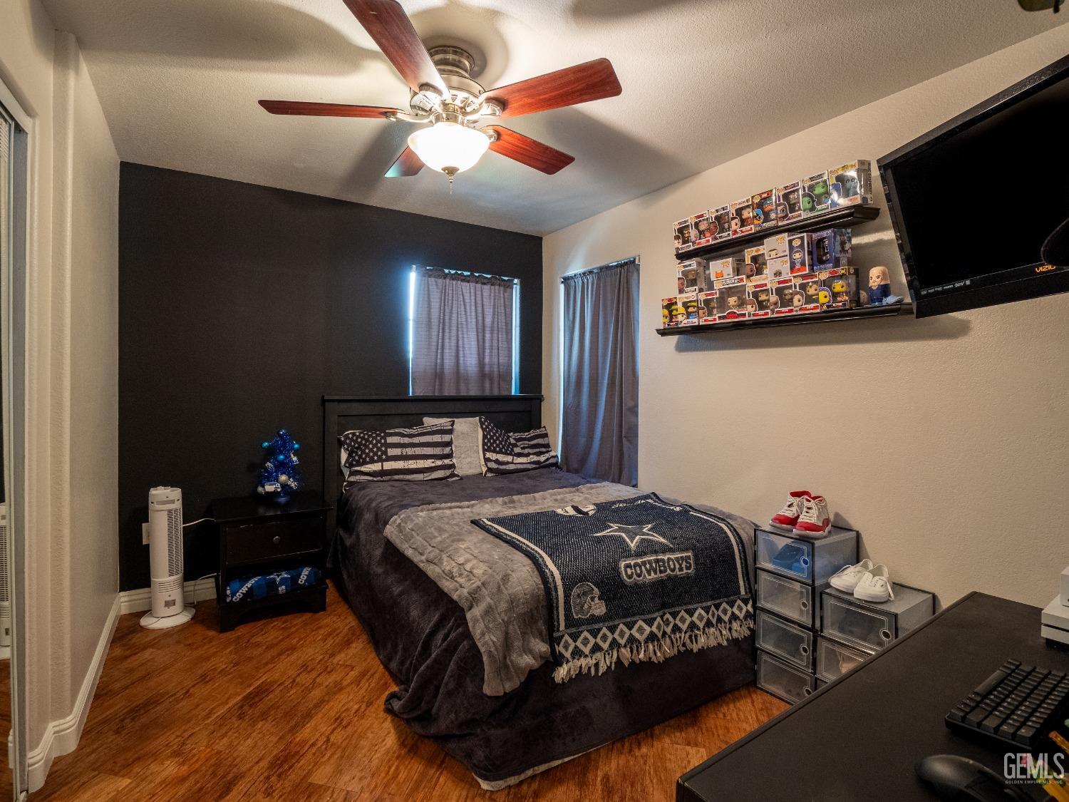 Undisclosed Address Bakersfield, CA 93312 - Photo 12 of 25 a bedroom with a bed and a flat screen tv