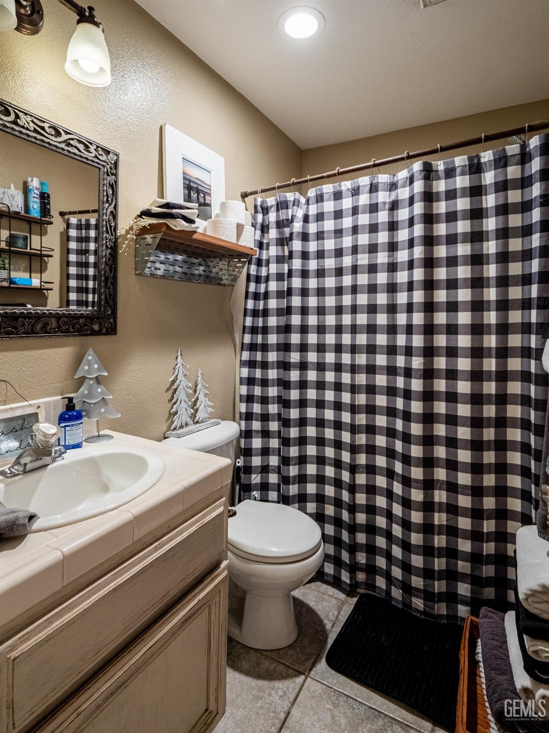 Undisclosed Address Bakersfield, CA 93312 - Photo 18 of 25 a bathroom with a sink toilet and shower