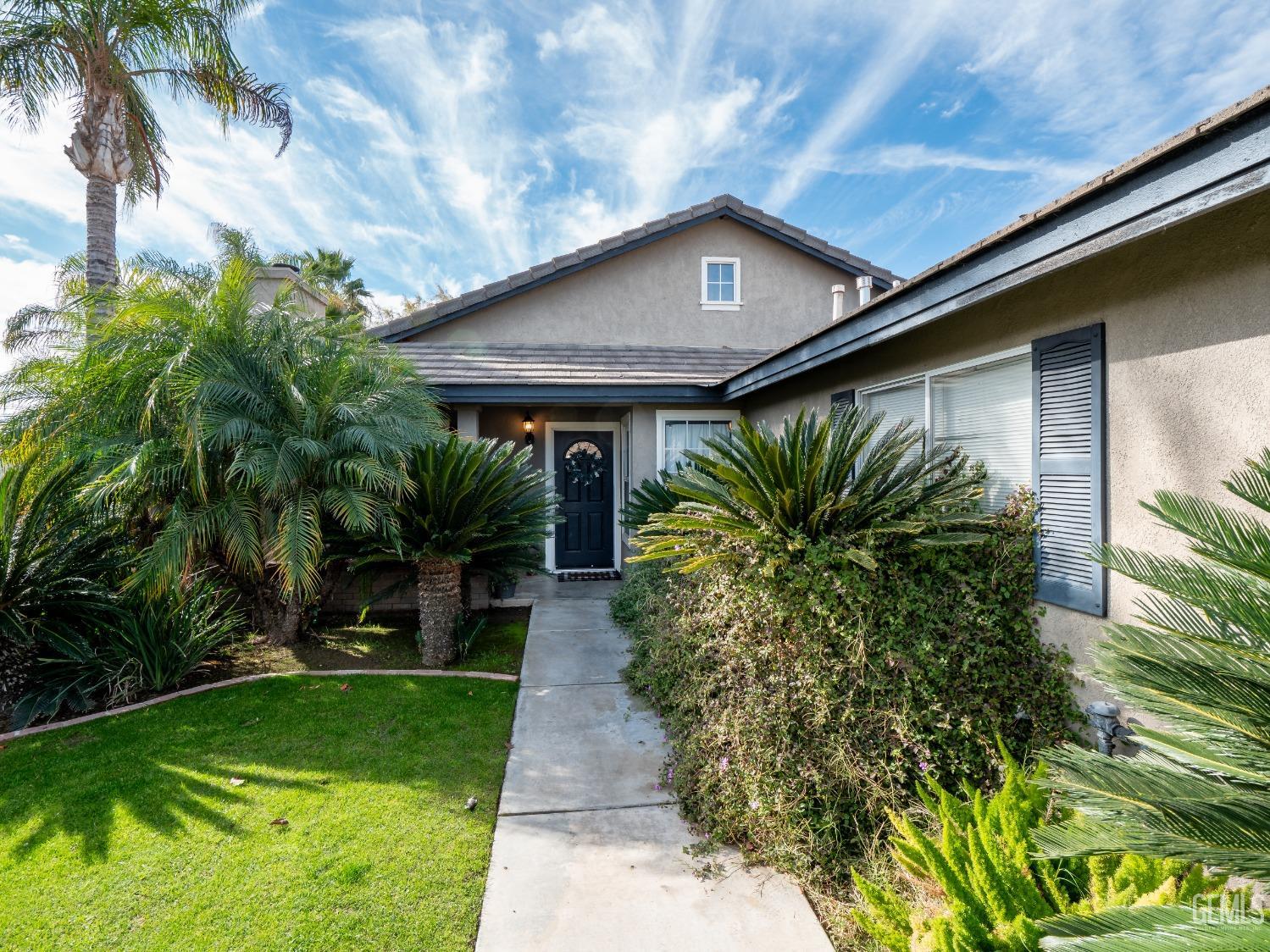 Undisclosed Address Bakersfield, CA 93312 - Photo 2 of 25 a flower garden is sitting in front of a house
