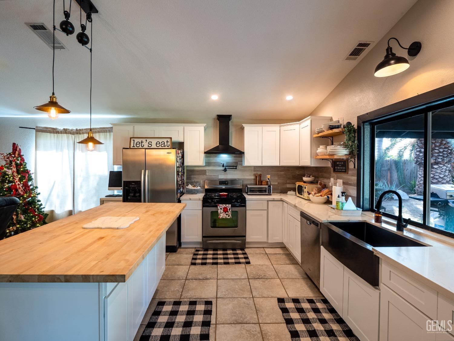 Undisclosed Address Bakersfield, CA 93312 - Photo 8 of 25 a kitchen with granite countertop a refrigerator and a sink