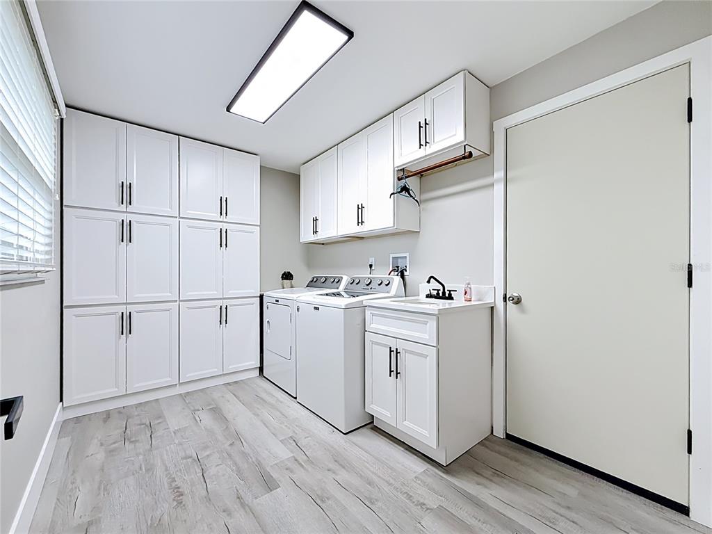 508 Shore Drive Largo, FL 33771 - Photo 21 of 31 a kitchen with cabinets wooden floor and a sink