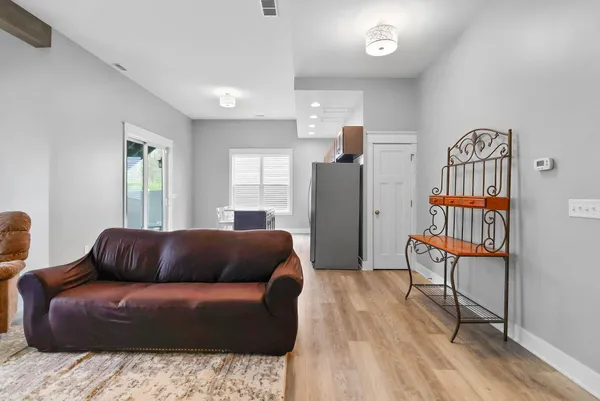 a living room with a couch and a book shelf