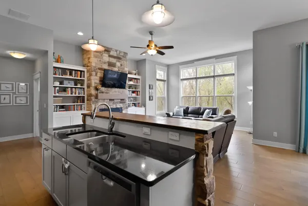 a kitchen with a sink a center island and stainless steel appliances