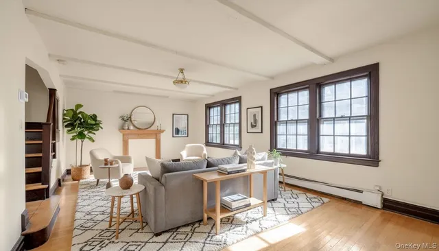 a living room with fireplace furniture and a large window