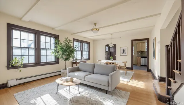 a living room with furniture and floor to ceiling windows
