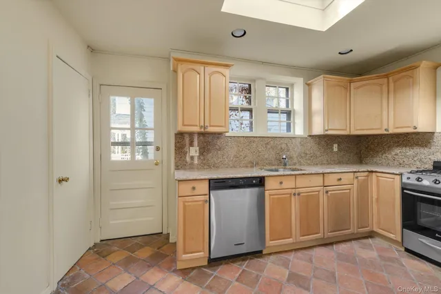 a kitchen with granite countertop a sink cabinets and window