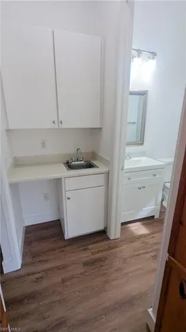 a kitchen with a sink a stove and cabinets