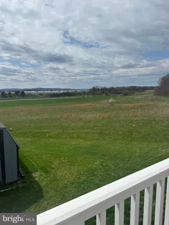 a view of a field with an ocean view