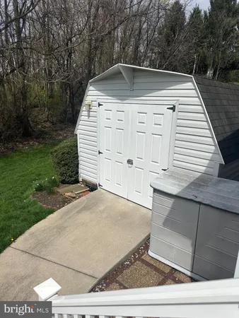 a view of a white house with a yard